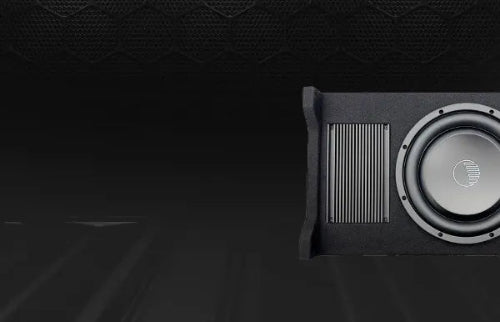 Car subwoofer installed in a vehicle's trunk.